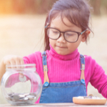 girl saving money in a jar